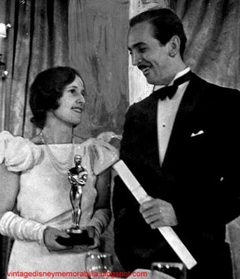 Oscary photo - 1931-32 Walt Disney  with his first Oscar for Flowers...oons stands next to his wife who holds his statuette.jpg